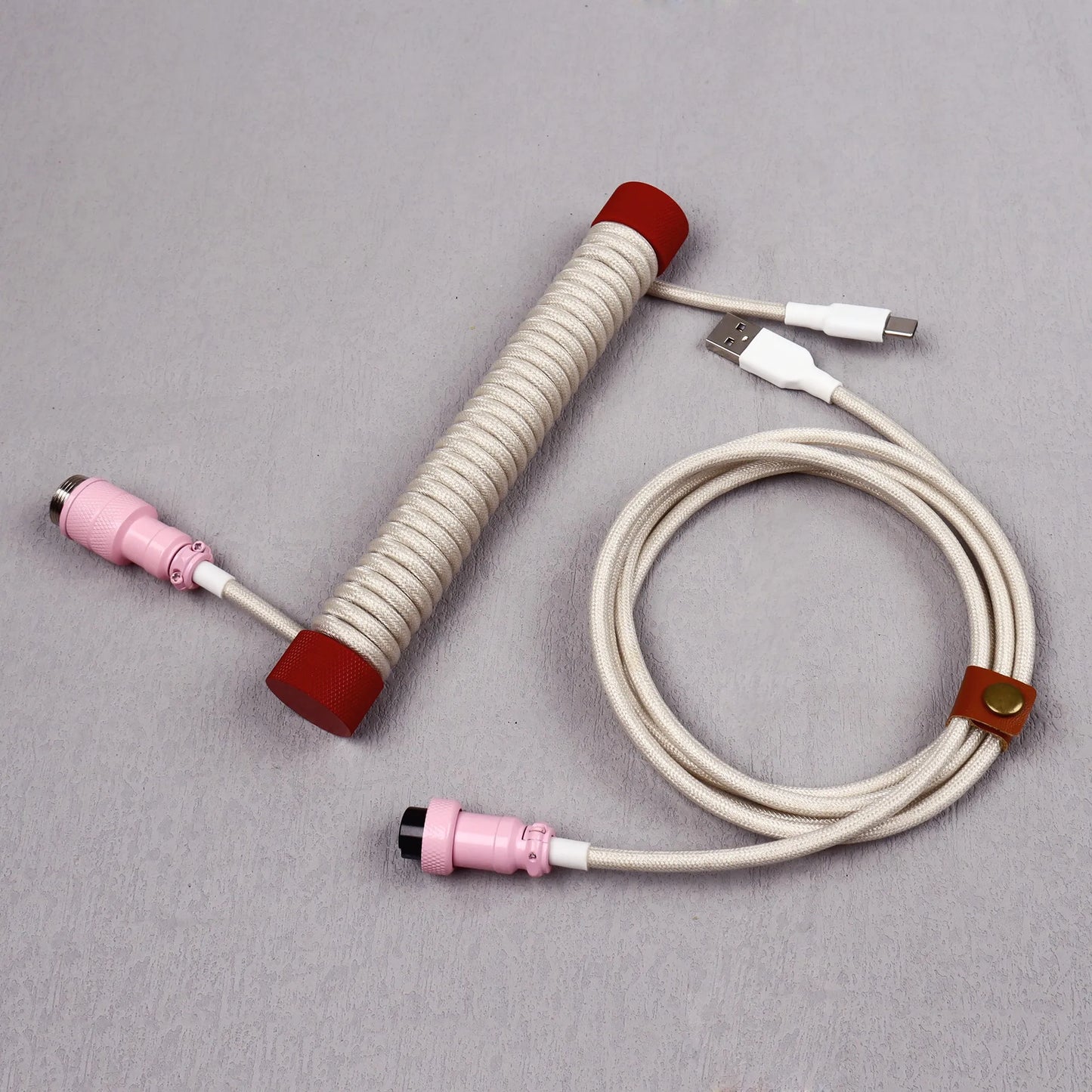 Coiled cable with connectors on a gray background