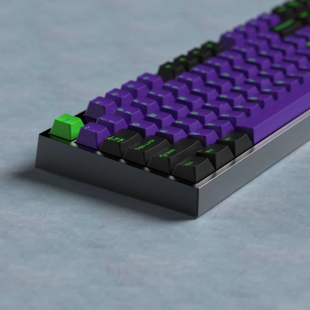 Mechanical keyboard with purple and black keys on a gray surface