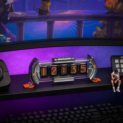 Nixie tube clock on a desk with a computer setup in the background