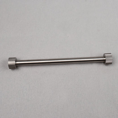 Metal rod with hexagonal ends on a gray background