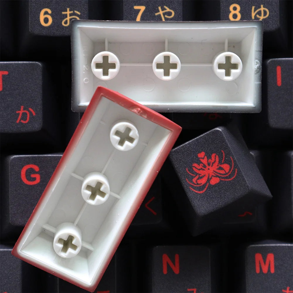 Close-up of keyboard keys with white and red keycaps on a black background