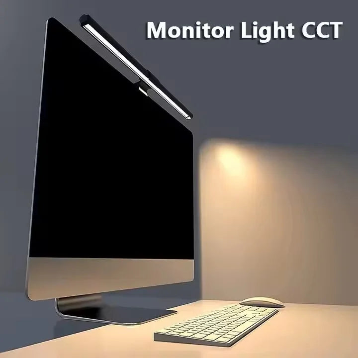 Computer monitor with a light strip on the side emitting a warm glow.