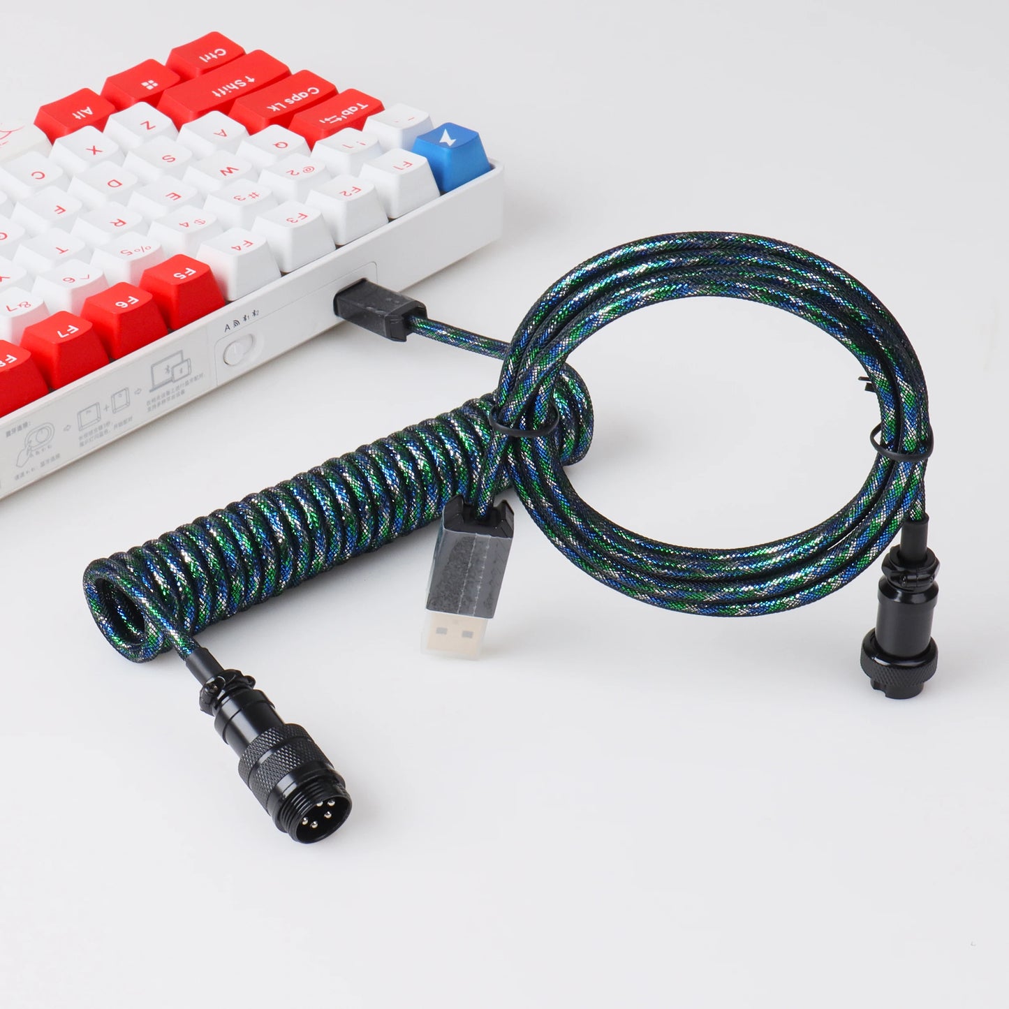 Coiled keyboard cable with connectors on a white background