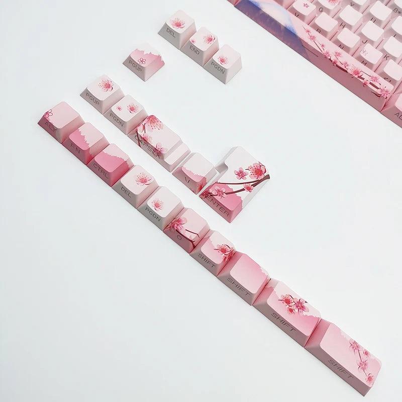 Keyboard keycaps with cherry blossom design on a white background