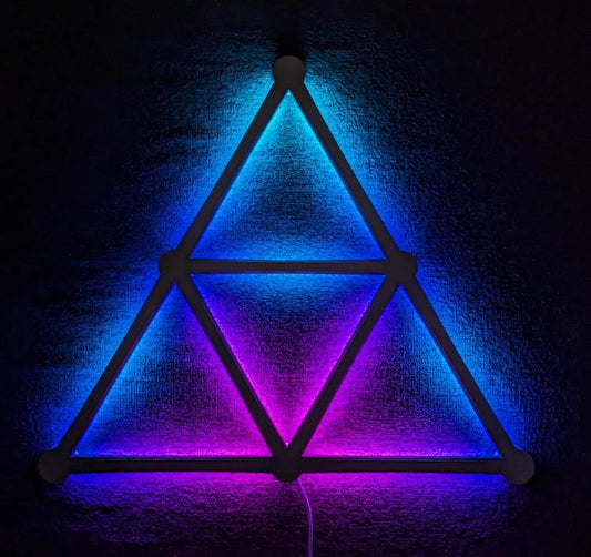 Neon triangular light fixture on a textured wall with blue and purple hues.