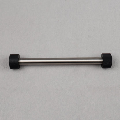 Metal bar with black ends on a gray background