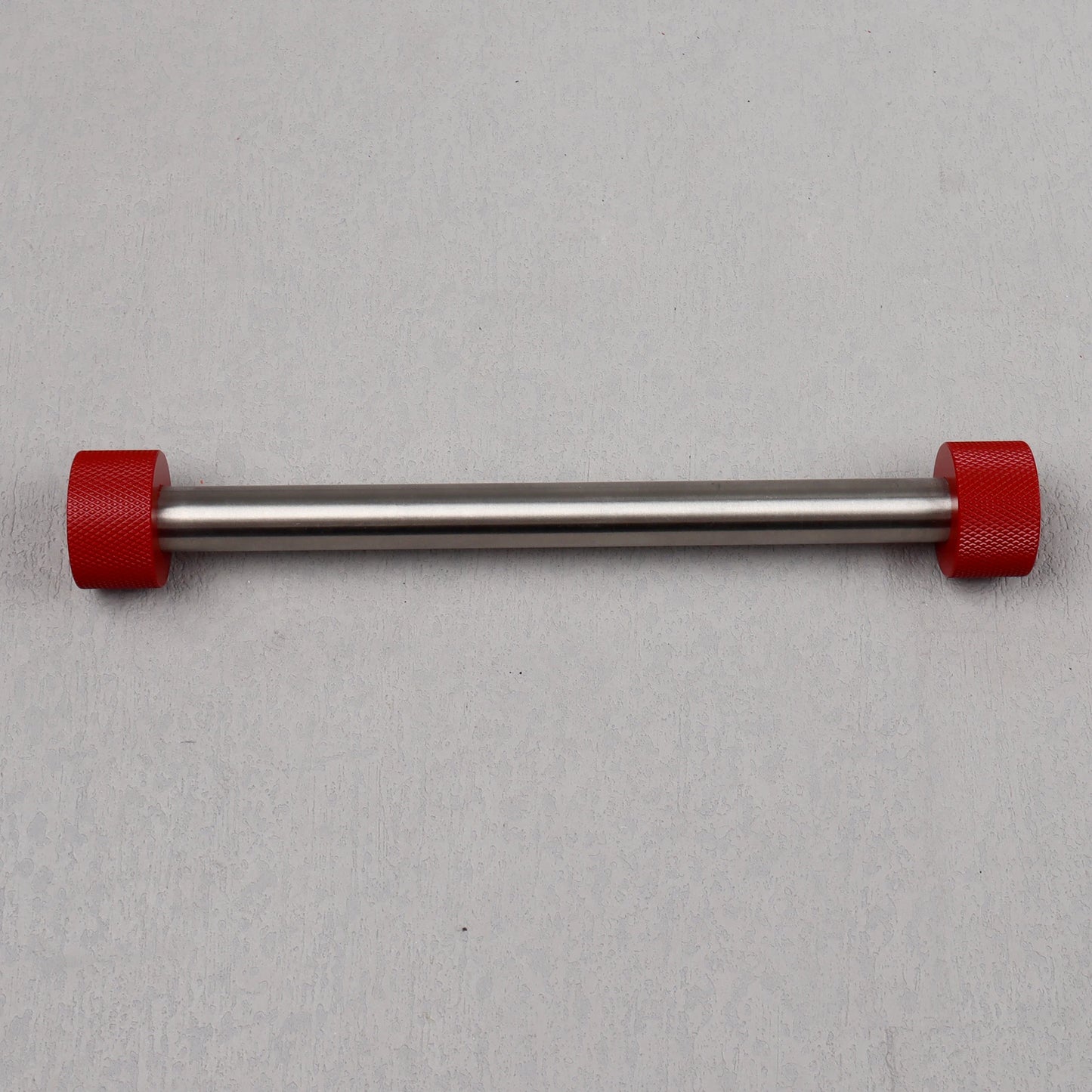 Metal bar with red ends on a gray background