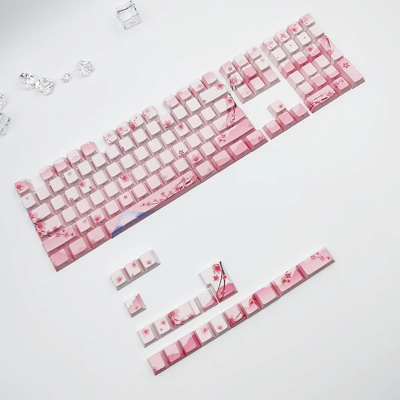 Pink keyboard with cherry blossom design on a white background