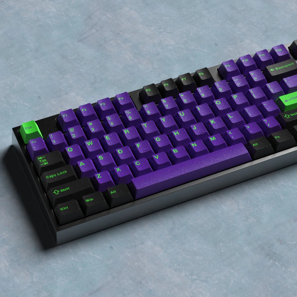 Mechanical keyboard with purple and black keys on a gray surface