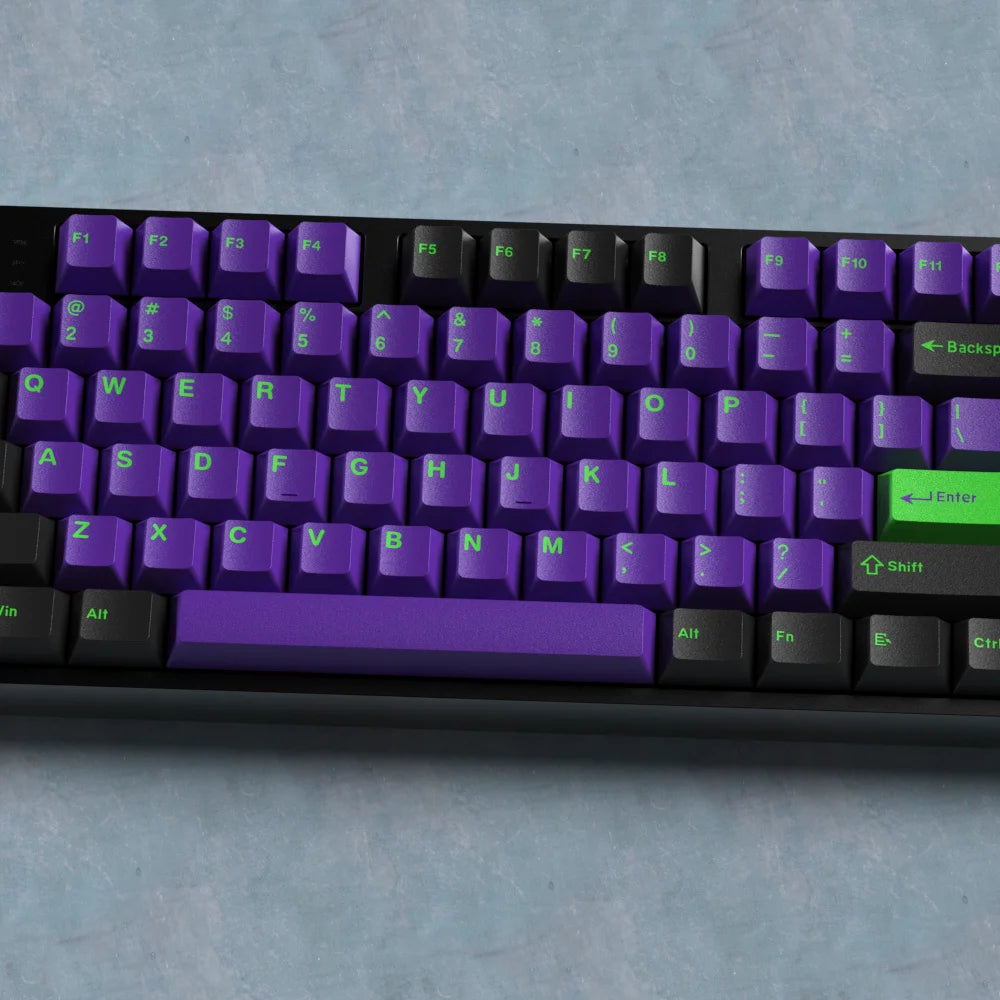Purple keyboard with green accents on a gray surface