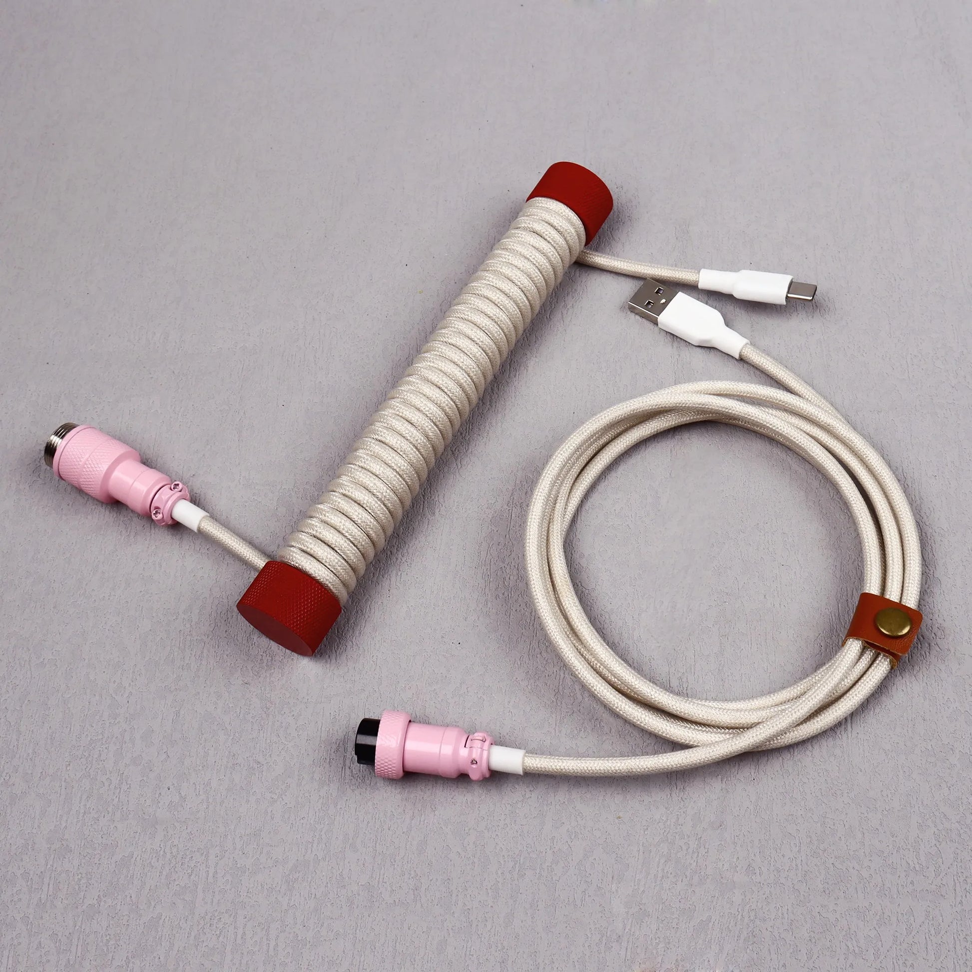 Coiled cable with connectors on a gray background