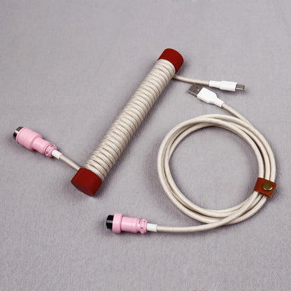 Coiled cable with connectors on a gray background