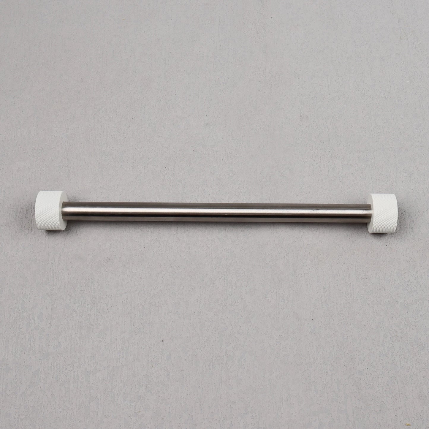 Metal rod with white ends on a gray background