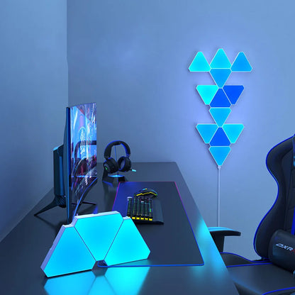 Modern gaming desk setup with geometric LED lights on a wall.