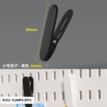 Black clamps with measurements on a gray background