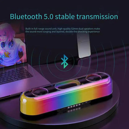 Colorful Bluetooth speaker with laptop in the background, emphasizing Bluetooth 5.0 transmission.