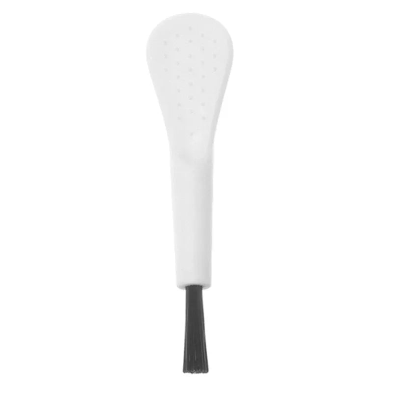 White ceramic spoon with black handle on a white background