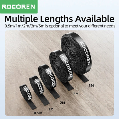 Set of black_ROCOREN straps with varying lengths on a wooden surface