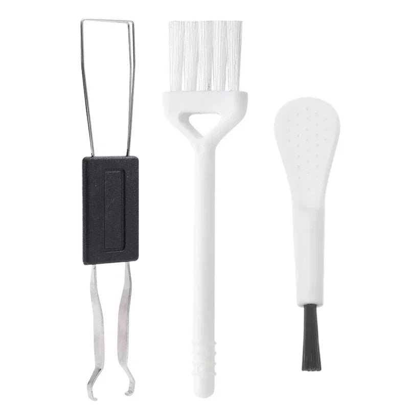 Set of three kitchen utensils including a spatula, a brush, and a ladle on a white background.