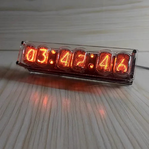 Digital clock with orange LED display on a wooden surface
