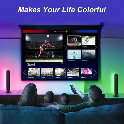 People watching a TV screen displaying various categories with colorful ambient lighting.