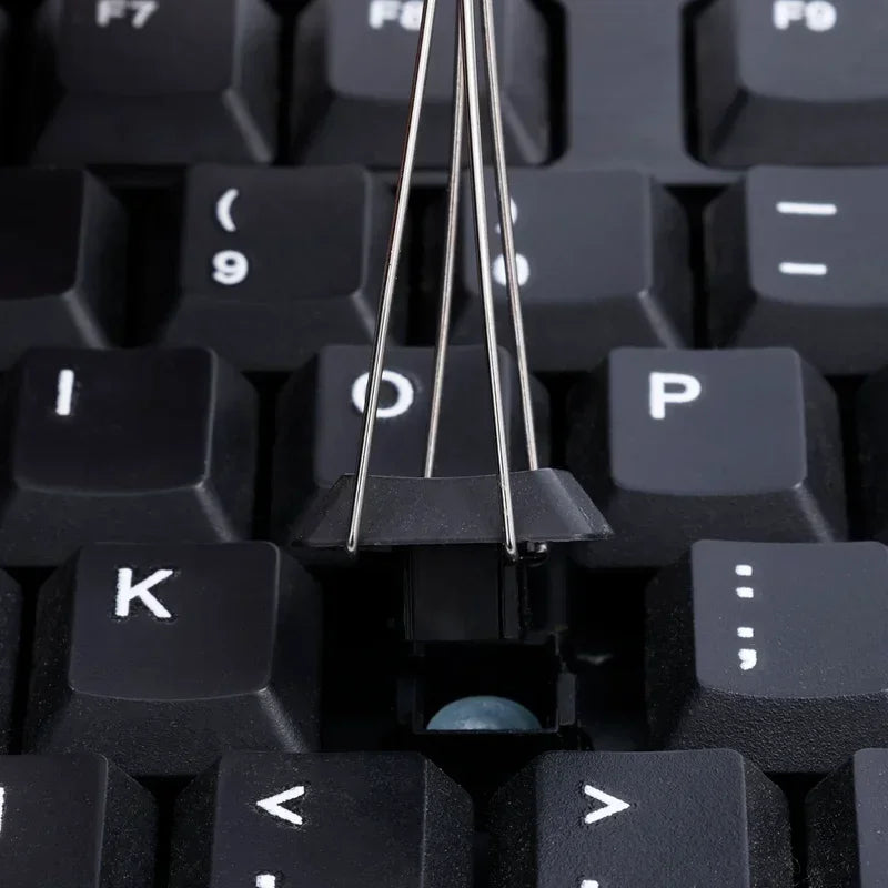 Close-up of a mechanical keyboard with a key cap missing, revealing the internal components.