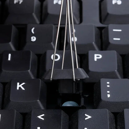 Close-up of a mechanical keyboard with a key cap missing, revealing the internal components.