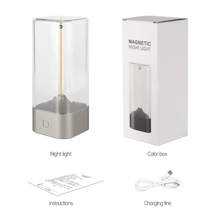 Magnetic night light with packaging, instructions, and charging cable on a white background