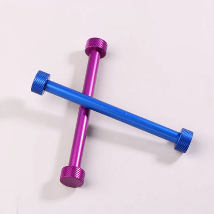 Two crossed metal bars, one purple and one blue, on a white background