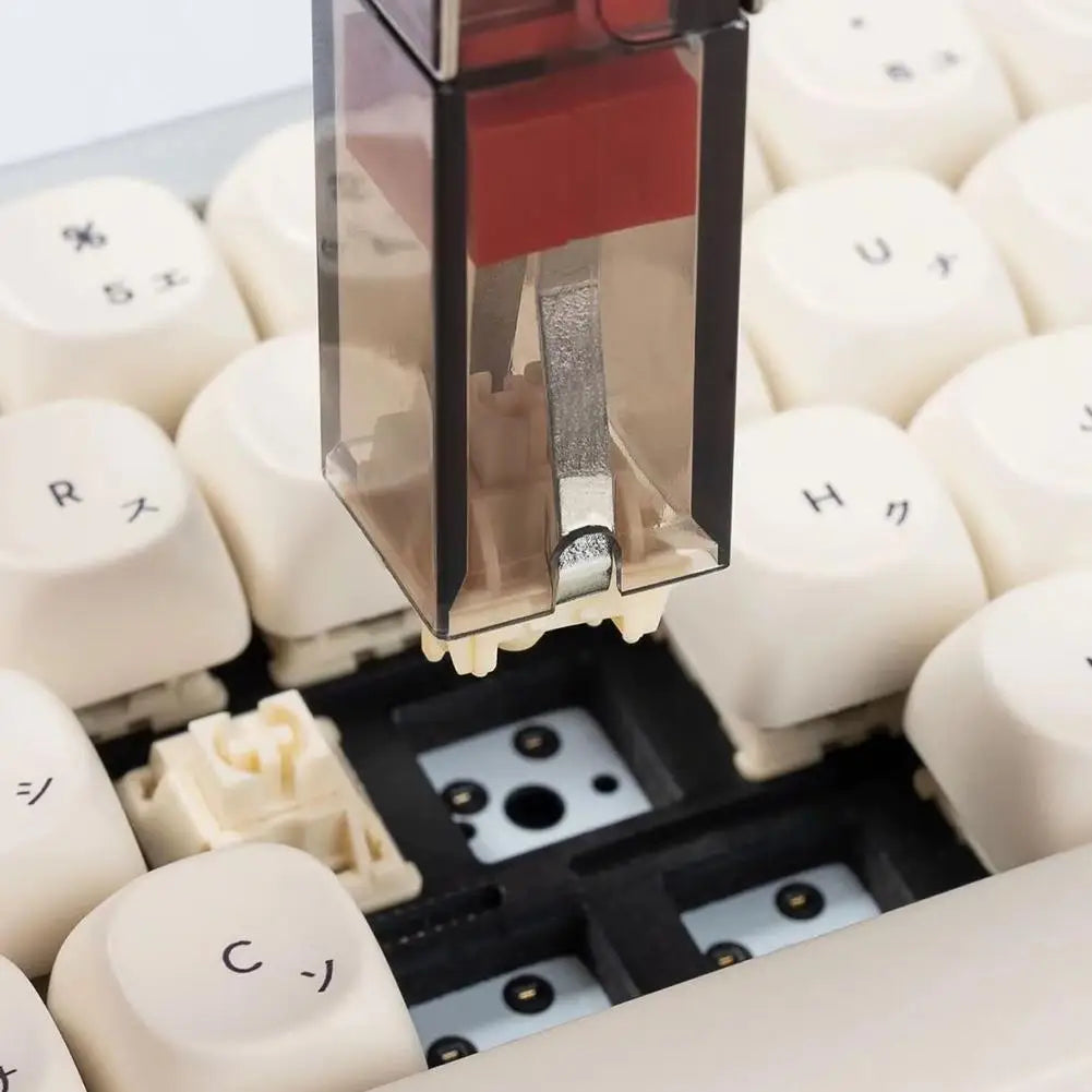 Close-up of a mechanical keyboard with white keys and visible key mechanism.
