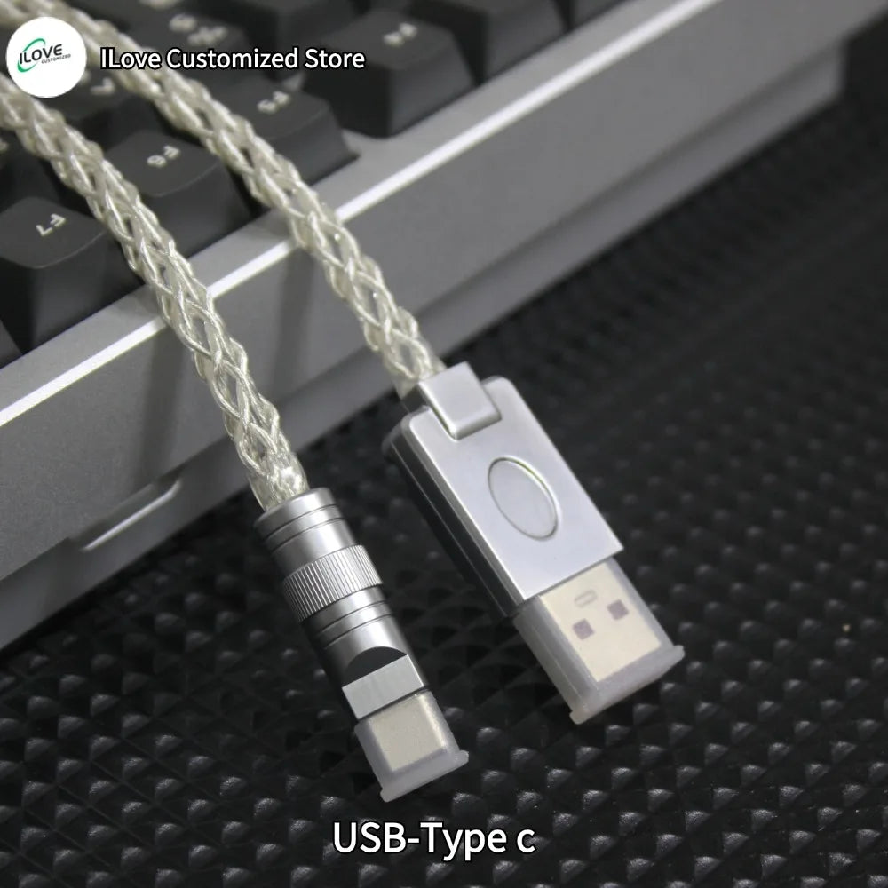 USB-Type C cable and adapter on a textured surface with keyboard in the background