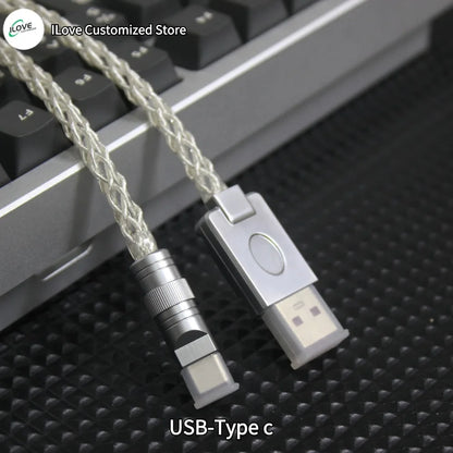 USB-Type C cable and adapter on a textured surface with keyboard in the background