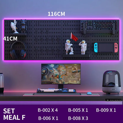 Gaming setup with monitor, keyboard, and other peripherals on a desk with a wall-mounted pegboard.