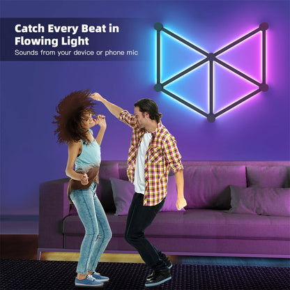 Two people dancing in a living room with a colorful geometric light fixture on the wall.