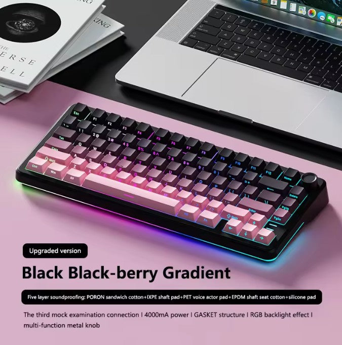 Blackberry gradient keyboard on a pink surface with a laptop in the background