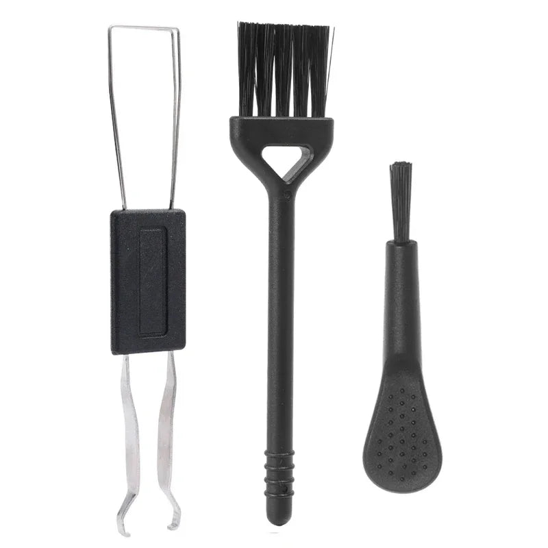 Set of three black cleaning brushes on a white background