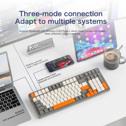 Keyboard with three-mode connection features on a desk with electronic devices.