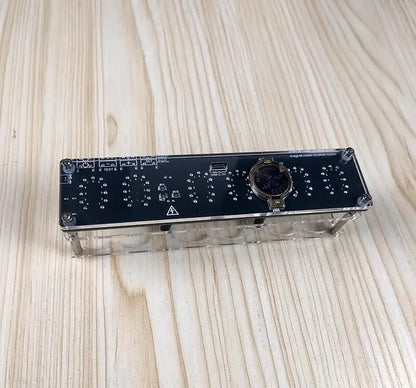 Electronic module with control knobs and display on a wooden surface