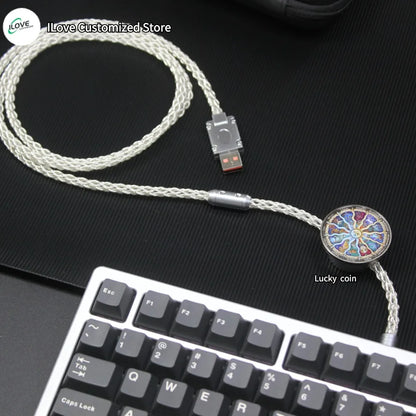 USB cable with a decorative end featuring a 'Lucky coin' design on a black surface.
