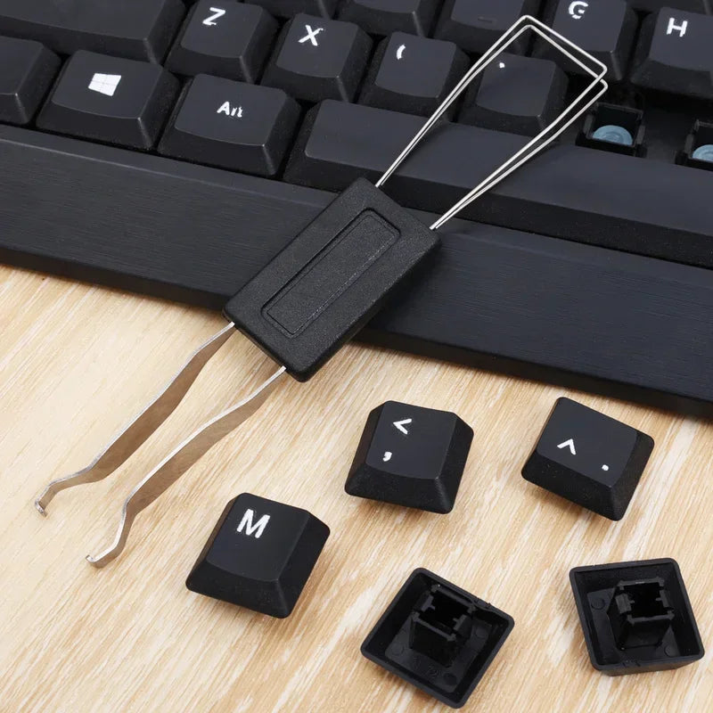 Black keyboard keys with a tool on a wooden surface