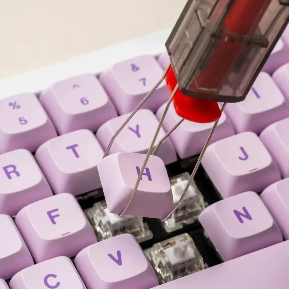 Close-up of a purple keyboard with a key being pressed, showing the internal mechanism.